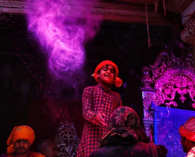 The smiling boy standing in front of people
